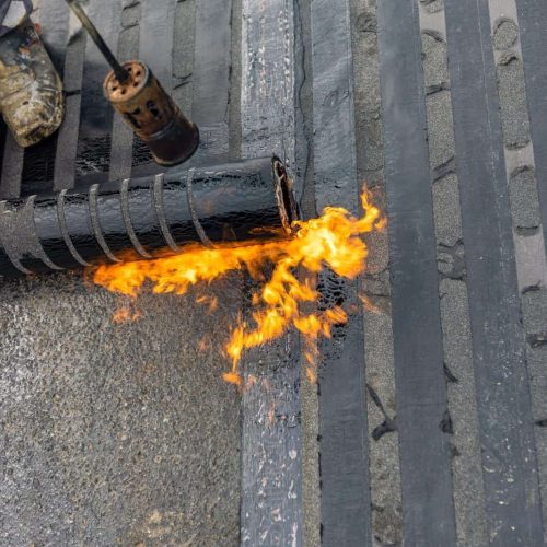 Bituminous membrane waterproofing system details and installation on flat rooftop.